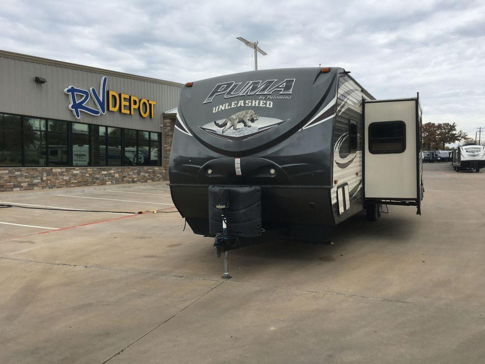 2015 PALOMINO PUMA UNLEASHED 30THS (4X4TPTF22FP) , Length: 35.33 ft. | Dry Weight: 7,345 lbs. | Gross Weight: 10,879 lbs. | Slides: 1 transmission, located at 4319 N Main St, Cleburne, TX, 76033, (817) 678-5133, 32.385960, -97.391212 - The 2015 Palomino Puma Unleashed 30THS is a dual-axle steel wheel setup measuring 35.33 ft. in length. It has a dry weight of 7,345 lbs. and a GVWR of 10,879 lbs. Its exterior is a base color of tan with cool black graphics. It includes one power slide as well as one 16-foot power awning. This toy h - Photo #2